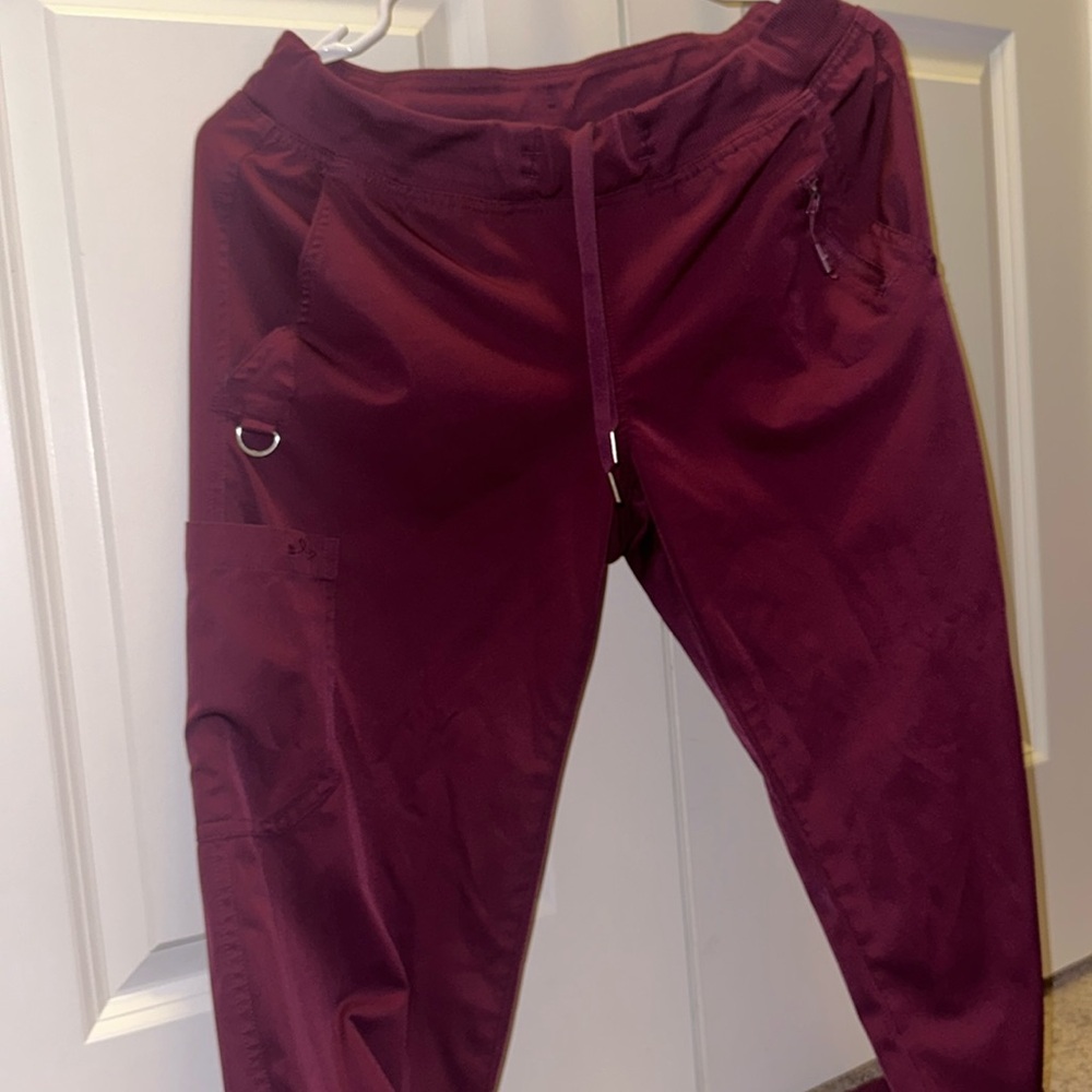Burgundy scrub pants.